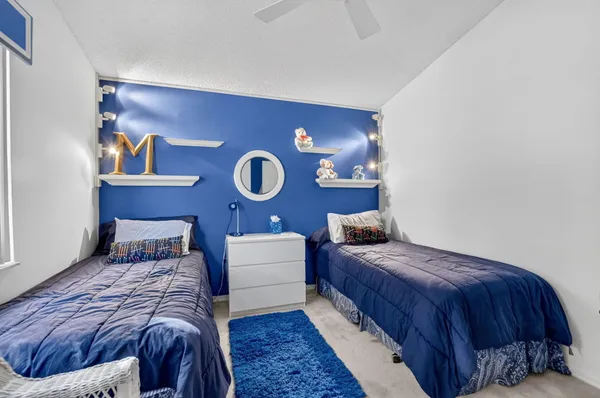 a bedroom with a bed and a lamp