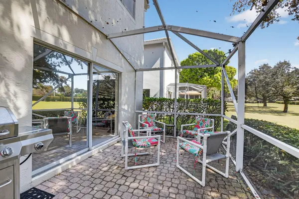 a view of a chairs and table in the balcony