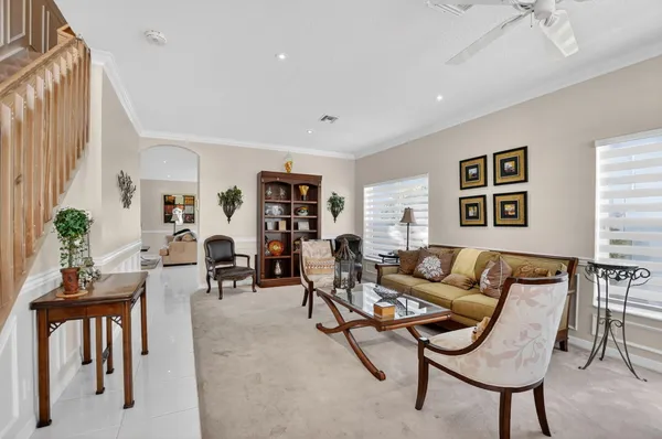 a living room with furniture and a potted plant