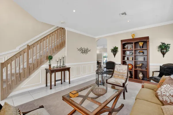 a living room with furniture and a book shelf