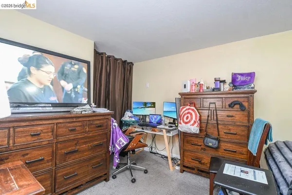 an empty room with wooden floor and door