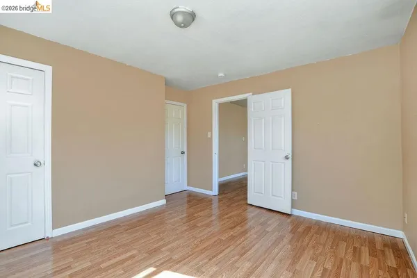 a view of an empty room and wooden floor
