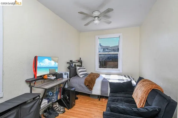 a bedroom with a bed and wooden floor