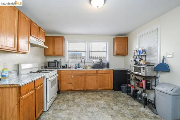 a kitchen with stainless steel appliances granite countertop a sink stove and cabinets