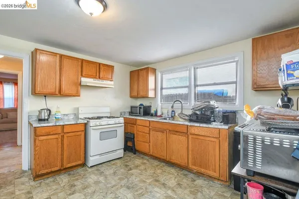 a kitchen with stainless steel appliances granite countertop a sink stove and cabinets