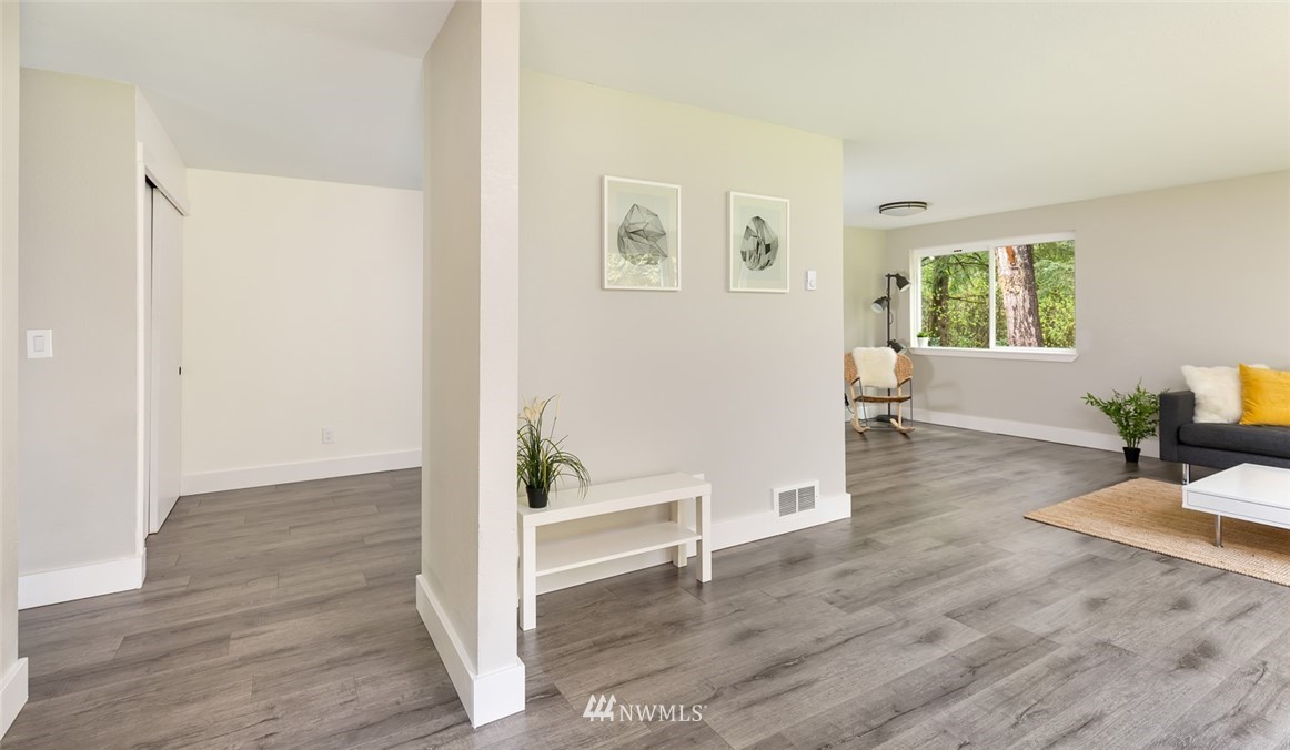 19129 Denmark Street Southwest Rochester, WA 98579 - Photo 6 of 21 a view of an empty room with wooden floor and a window
