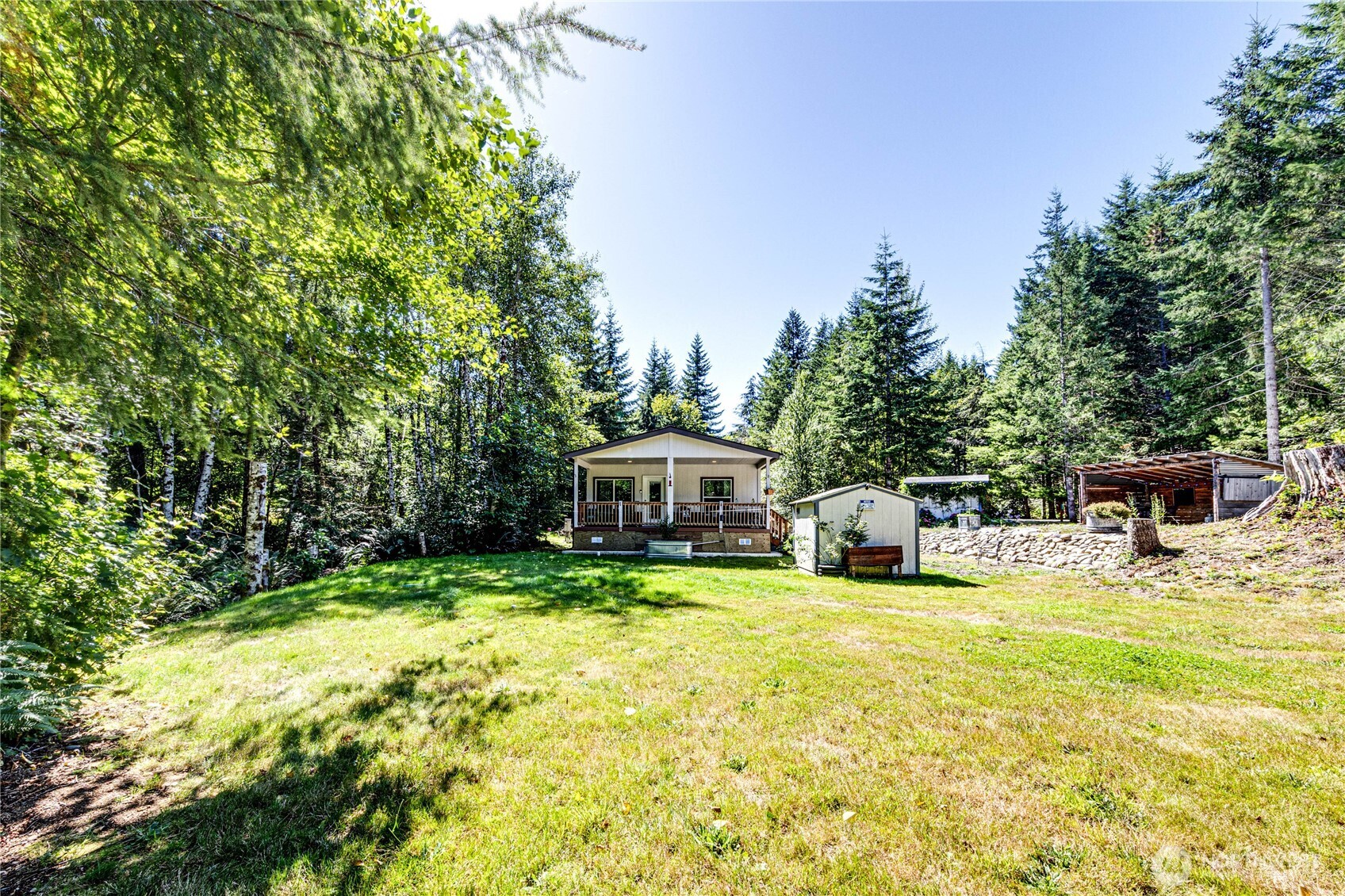 51 Sunflower Road Port Angeles, WA 98363 - Photo 21 of 40 a view of a swimming pool with a fountain and large trees