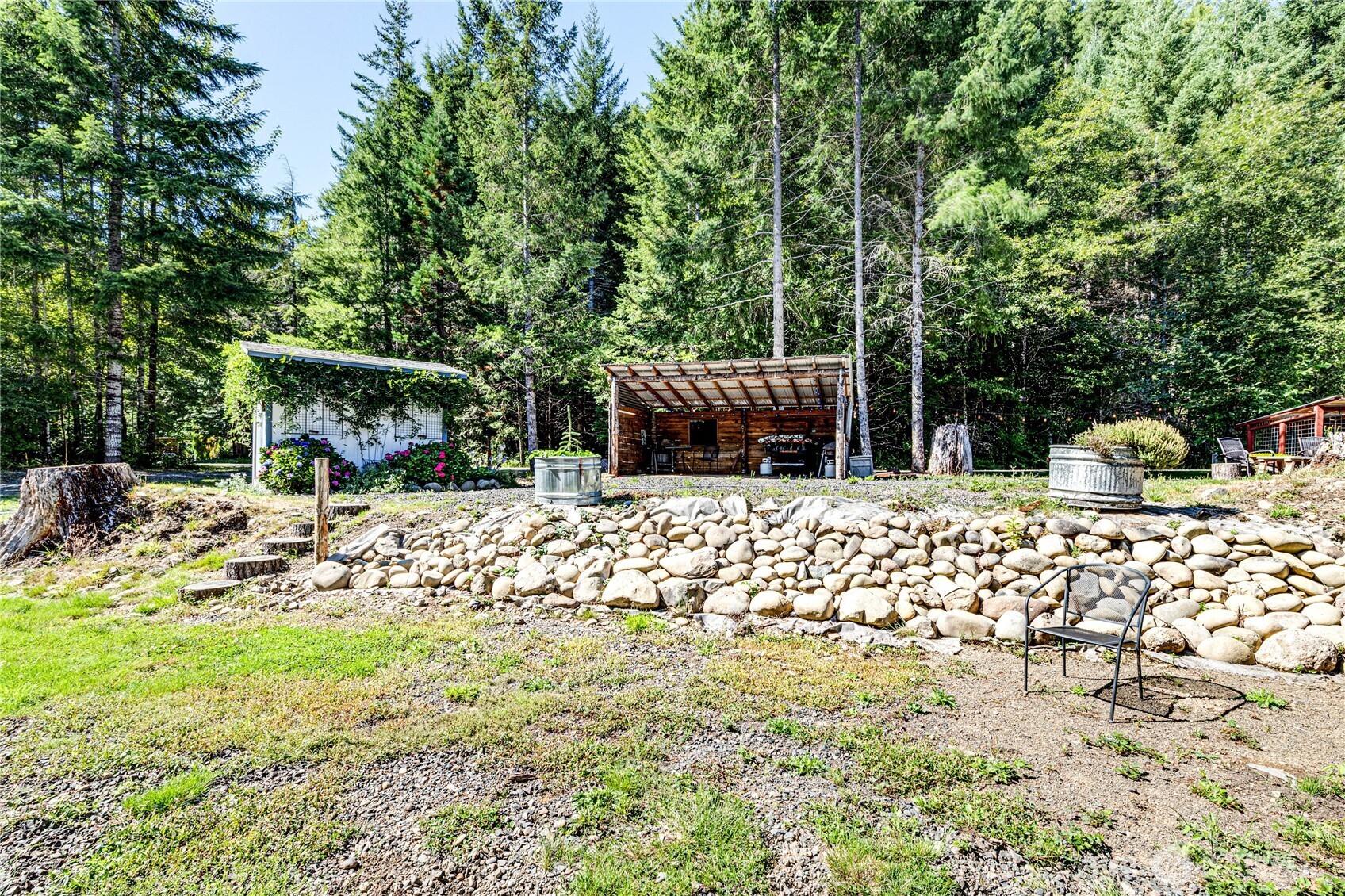 51 Sunflower Road Port Angeles, WA 98363 - Photo 23 of 40 a view of backyard with a garden and trees