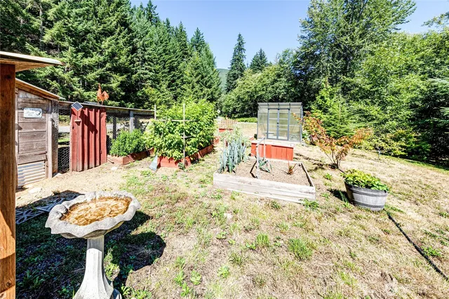 a view of a house with a small yard and potted plants