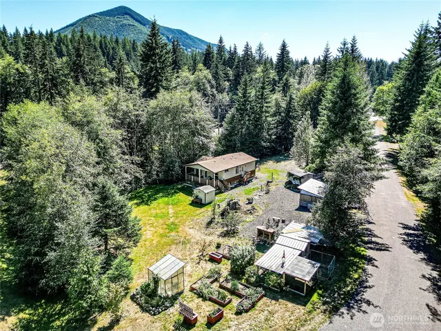 an aerial view of a house with swimming pool and patio