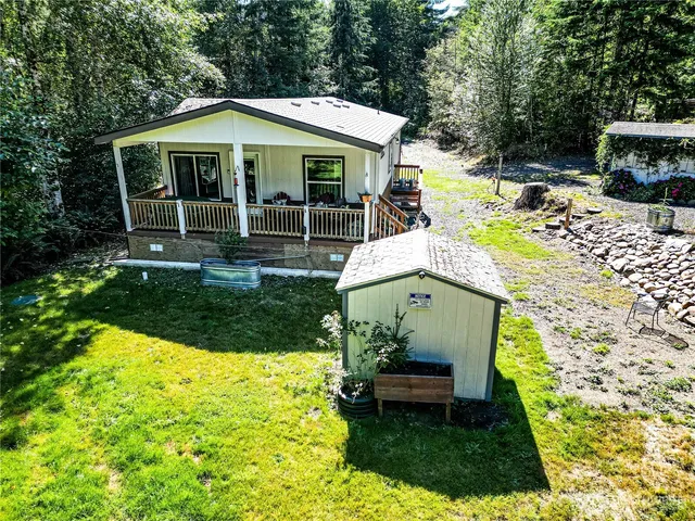 a view of a house with backyard porch and sitting area