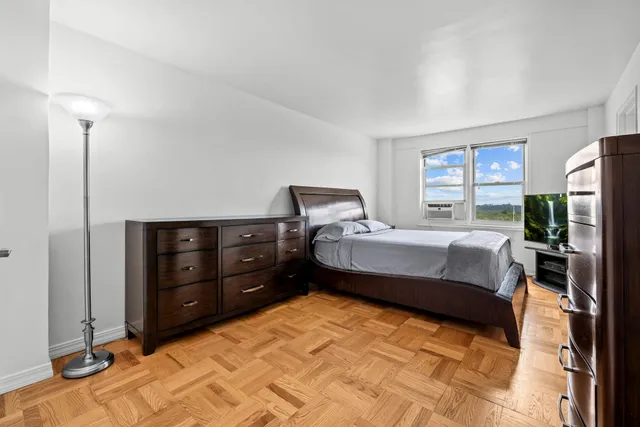 a bedroom with a bed and a night stand