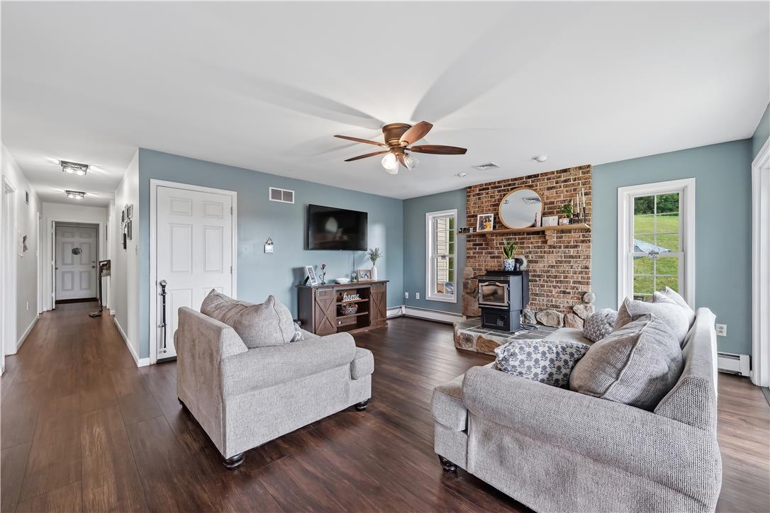 9868 Stagecoach Road Kempton, PA 19529 - Photo 8 of 17 A welcoming living area boasts rich hardwood floors and a cozy brick fireplace.