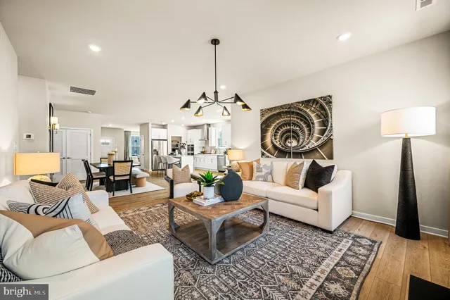 a living room with furniture a rug and a chandelier