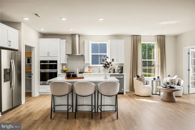 a kitchen with a table chairs stove and refrigerator