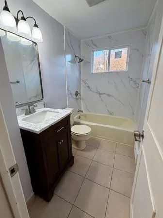 a bathroom with a double vanity sink toilet and shower