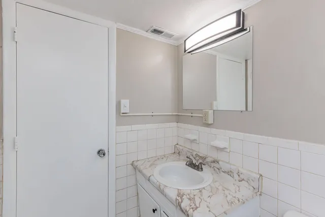 a bathroom with a sink and mirror
