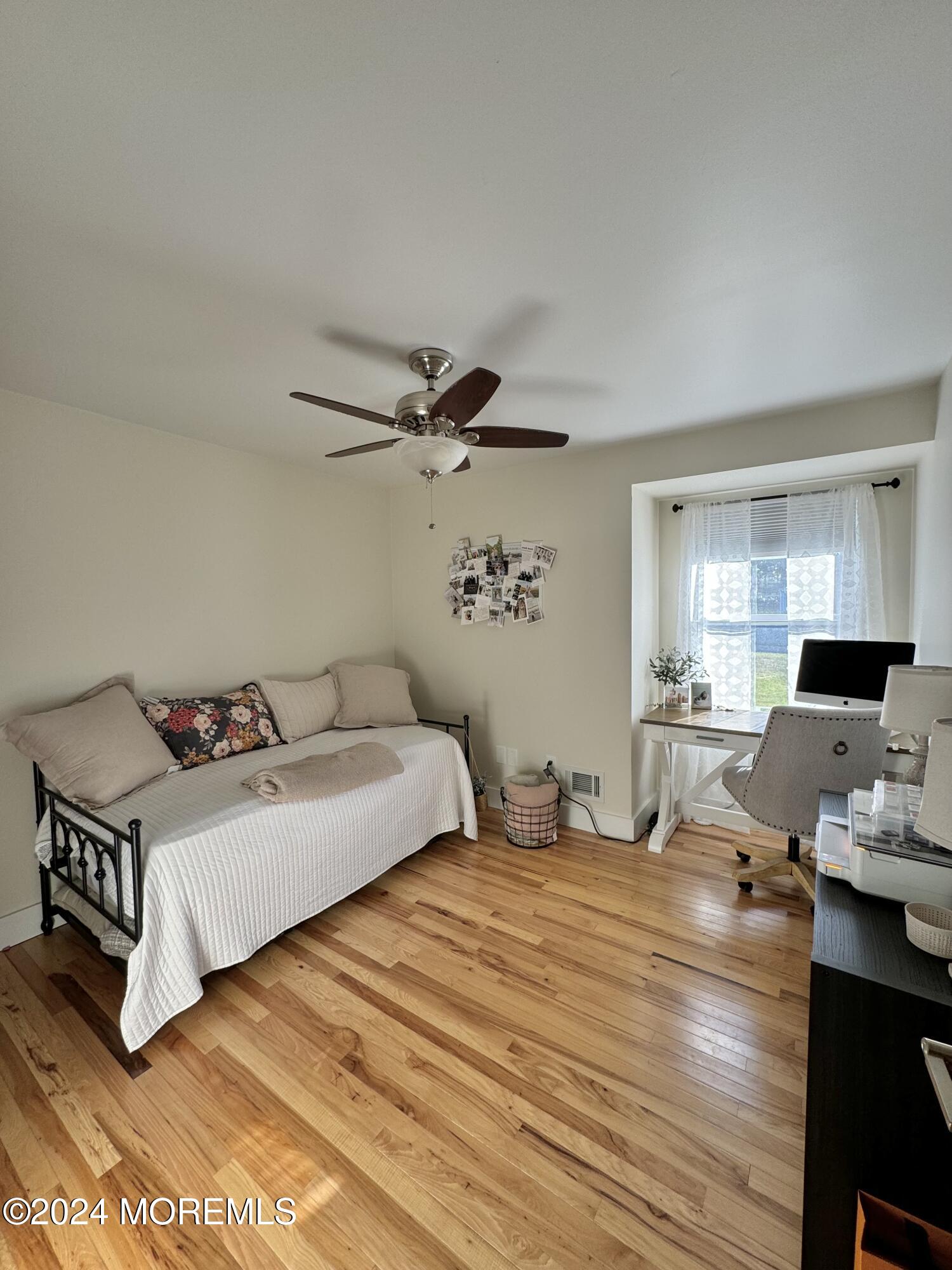 173 Topside Road Manahawkin, NJ 08050 - Photo 12 of 24 a bedroom with a bed and wooden floor