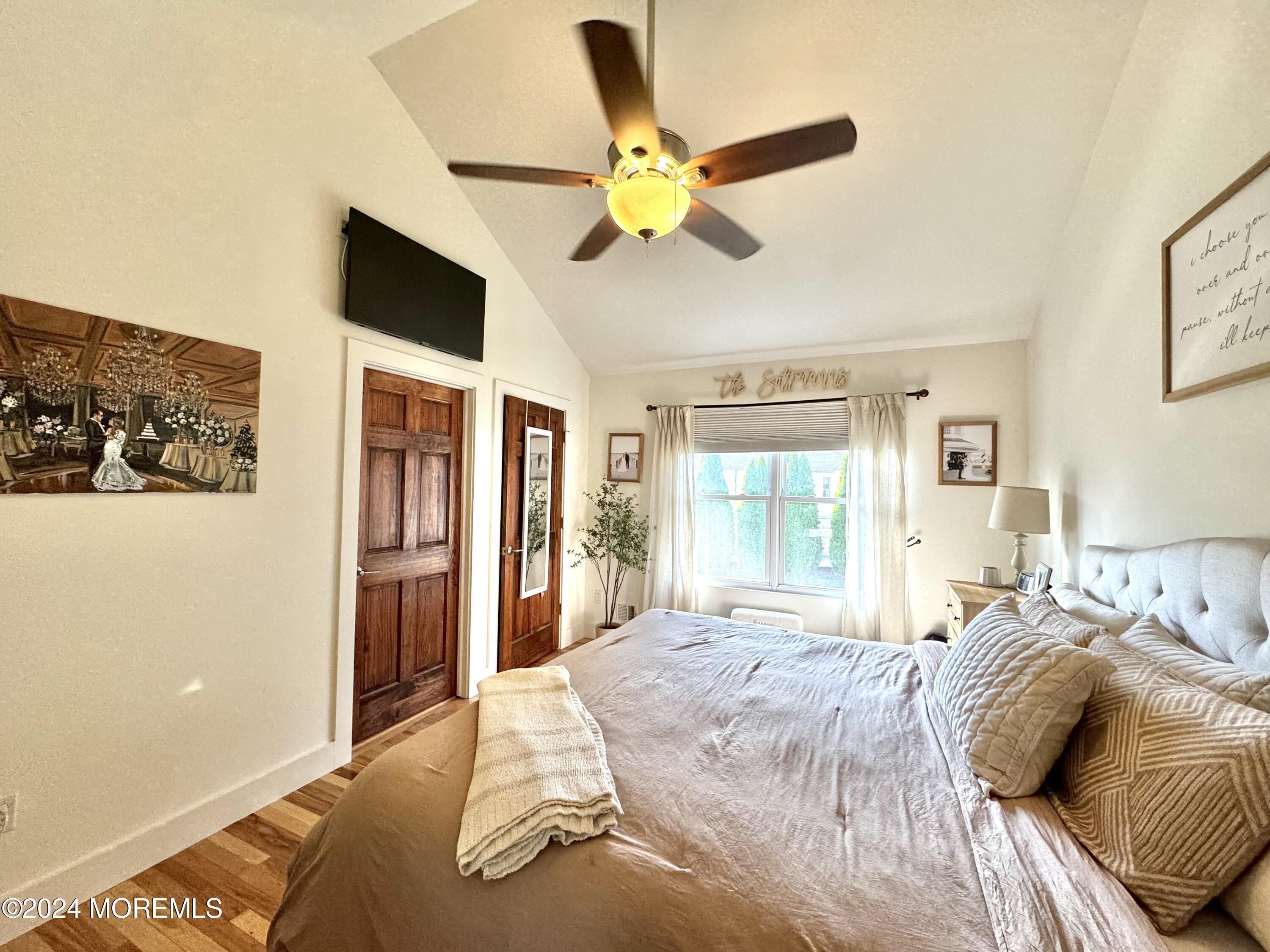 173 Topside Road Manahawkin, NJ 08050 - Photo 17 of 24 a bedroom with a bed and a large window