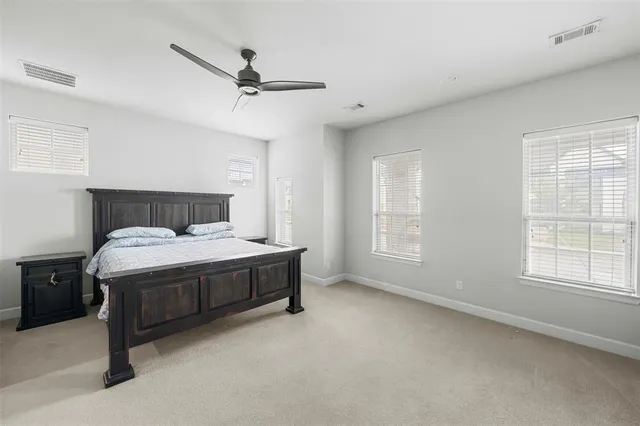 a bed sitting in a room next to a window