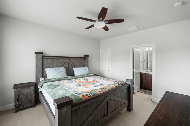 a bedroom with a bed and a ceiling fan