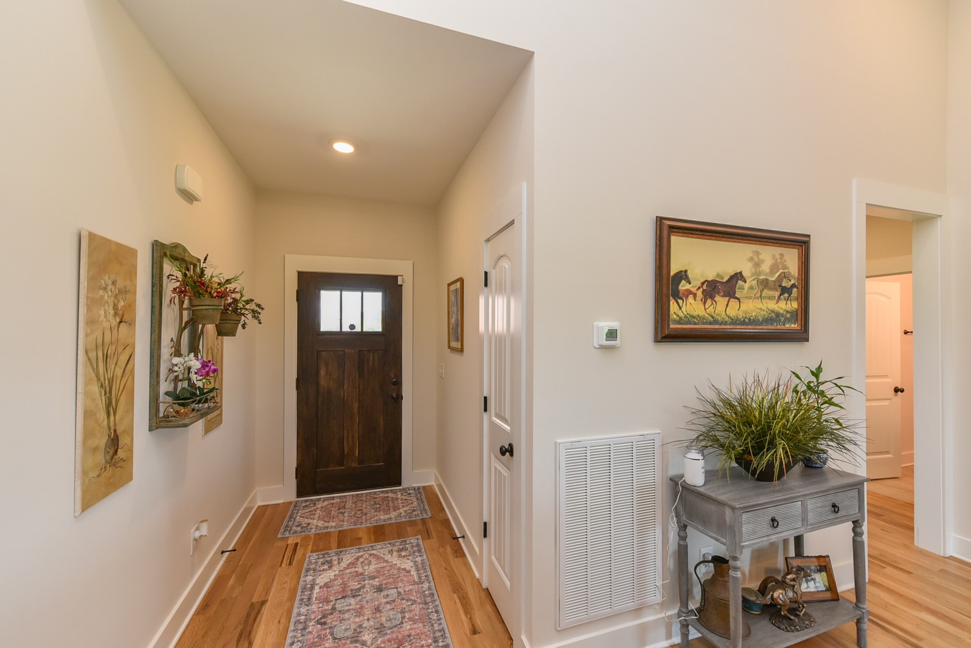4817 Barren Plains Road Springfield, TN 37172 - Photo 4 of 31 a hallway with painting on the wall and a potted plant