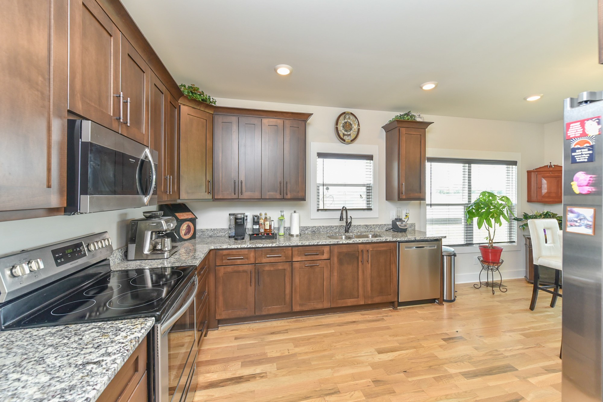 4817 Barren Plains Road Springfield, TN 37172 - Photo 8 of 31 a kitchen with stainless steel appliances granite countertop a stove top oven a sink dishwasher a dining table and chairs with wooden floor