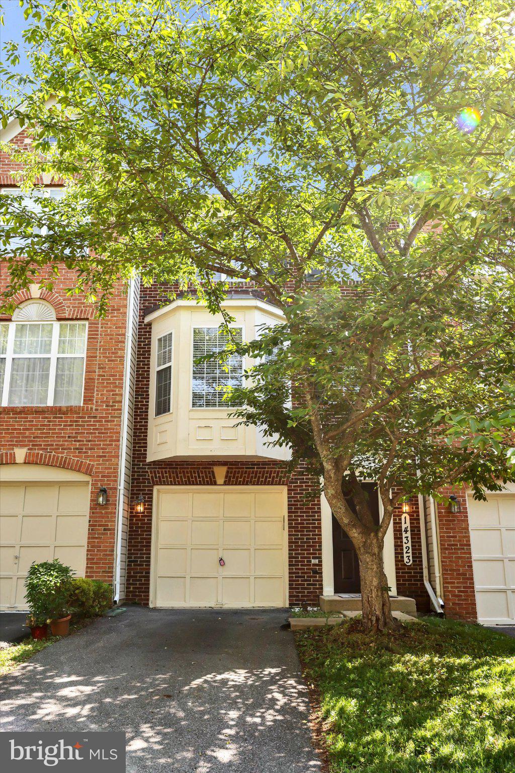 14323 Gate Dancer Lane Boyds, MD 20841 - Photo 3 of 54 Charming brick facade with lush greenery.