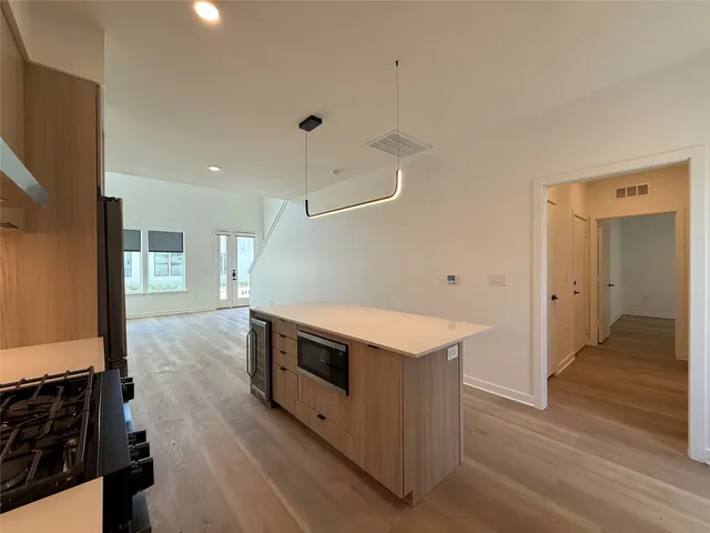 a kitchen with a stove and a refrigerator