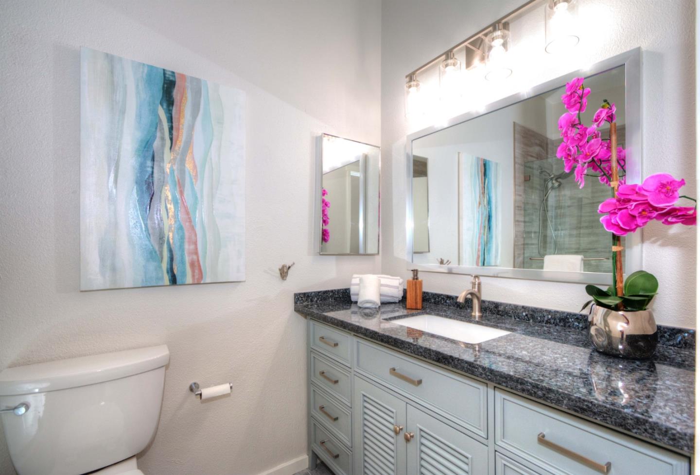 1 Farm Road Los Altos, CA 94024 - Photo 14 of 25 a bathroom with a granite countertop sink a large mirror and a toilet