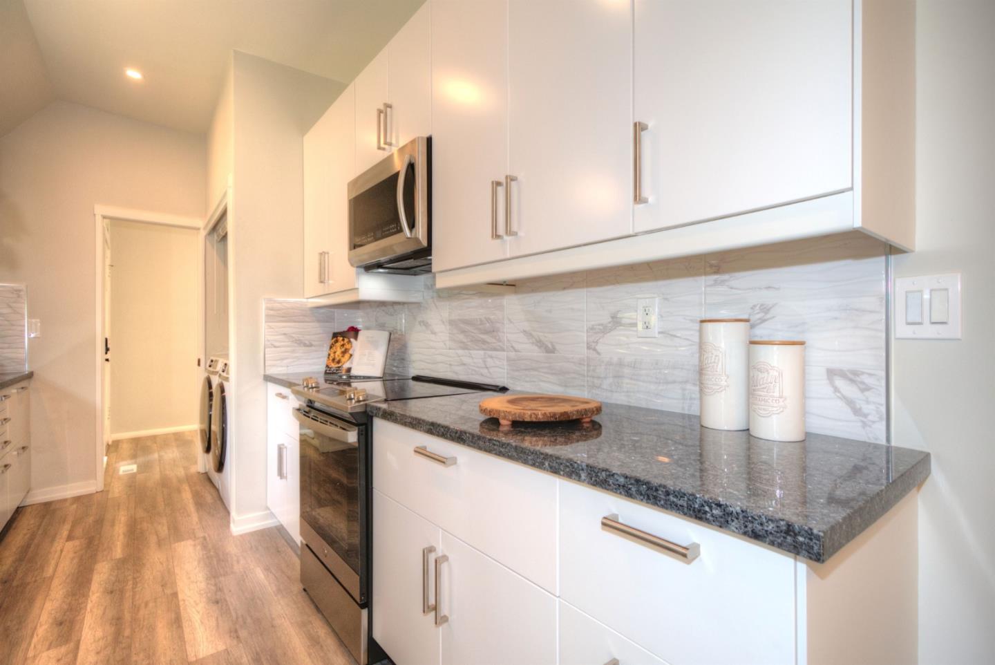 1 Farm Road Los Altos, CA 94024 - Photo 6 of 25 a kitchen with stainless steel appliances granite countertop a sink a stove and a microwave