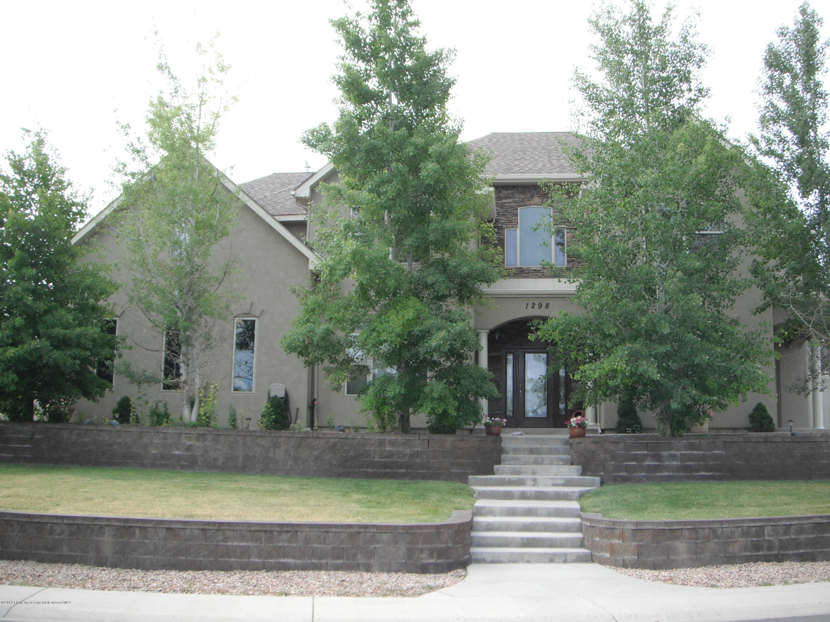 1298 Fir Avenue Rifle, CO 81650 - Photo 1 of 27 a front view of a house with garden