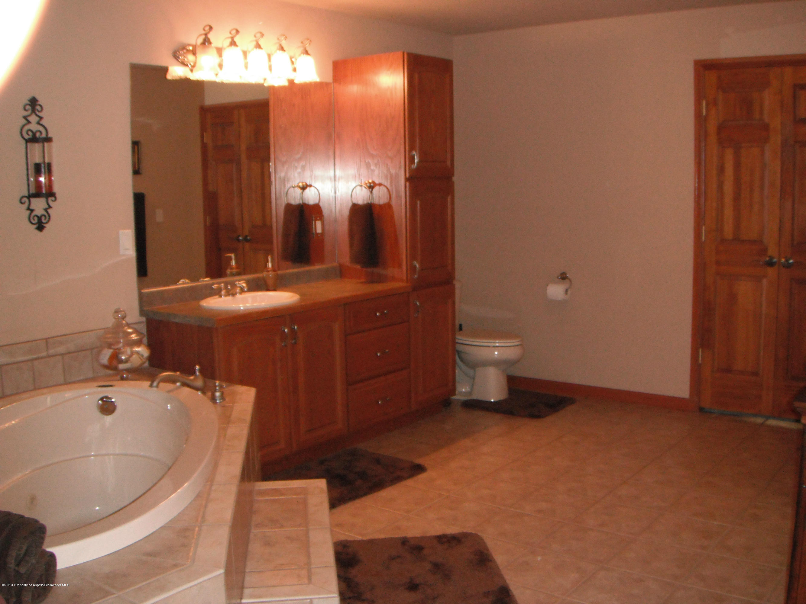 1298 Fir Avenue Rifle, CO 81650 - Photo 14 of 27 a bathroom with a tub sink and mirror