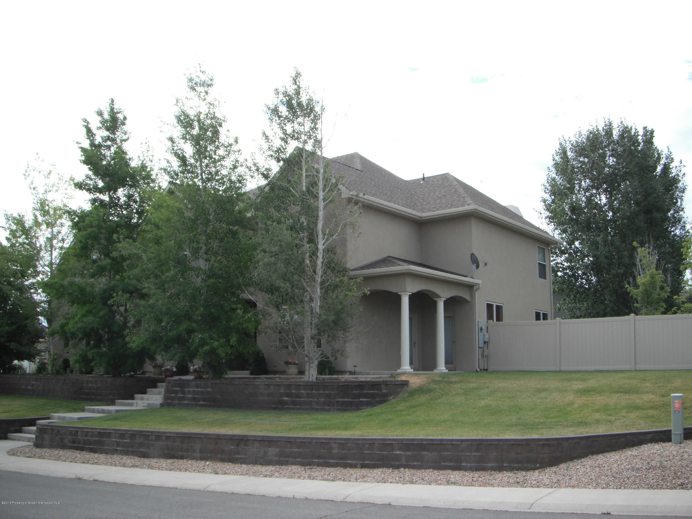 1298 Fir Avenue Rifle, CO 81650 - Photo 2 of 27 a front view of a house with a garden