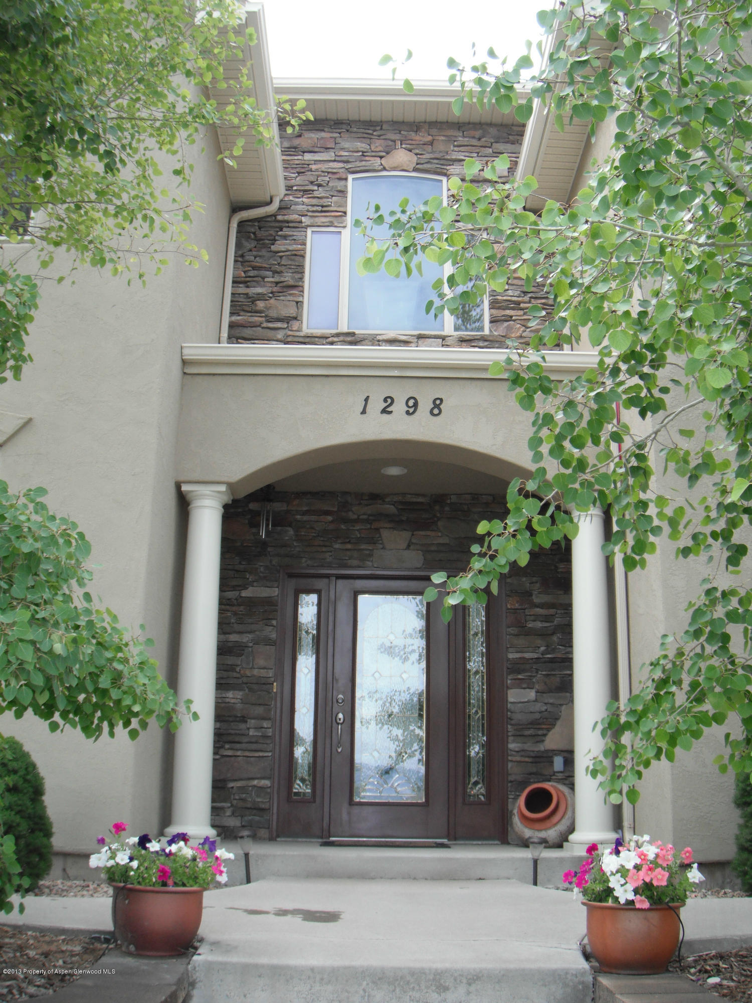 1298 Fir Avenue Rifle, CO 81650 - Photo 4 of 27 a front view of a house with plants