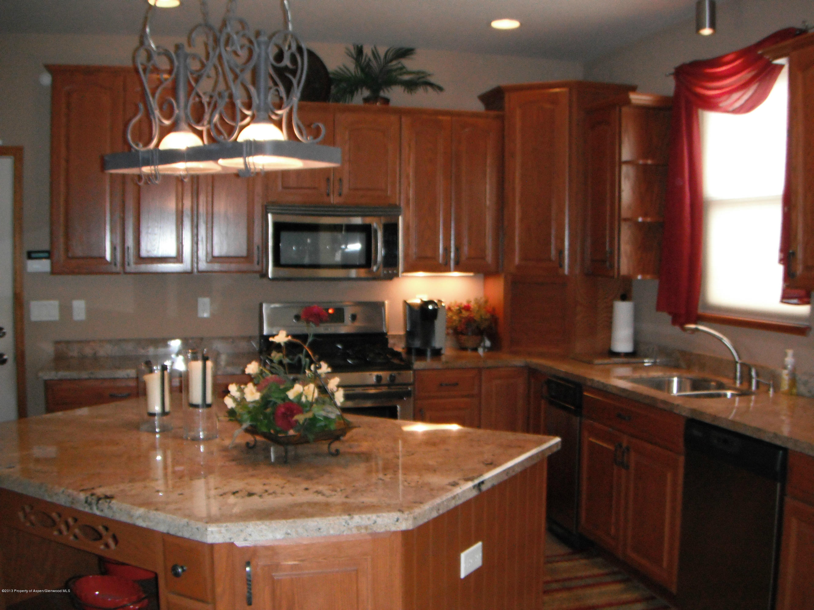 1298 Fir Avenue Rifle, CO 81650 - Photo 9 of 27 a kitchen with a stove a sink and a microwave