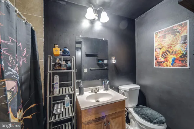 a bathroom with a toilet sink and mirror