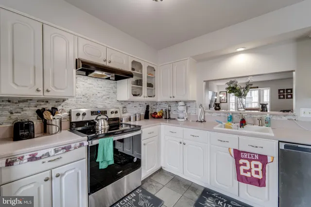 a kitchen with stainless steel appliances granite countertop a sink and cabinets