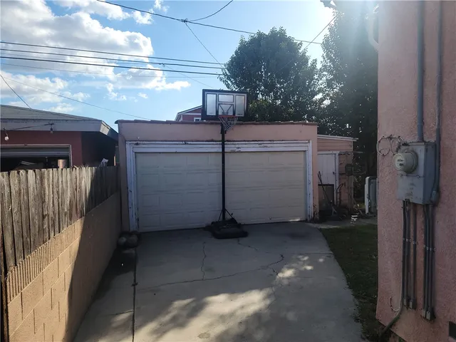 a view of a garage with wooden fence
