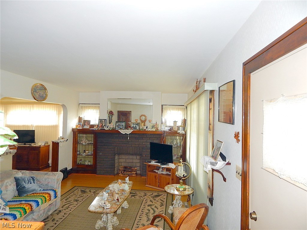 2212 Ralph Avenue Cleveland, OH 44109 - Photo 2 of 15 Front door enters into the living room with hardwood laminate flooring. Fireplace has a light feature to simulate fire.