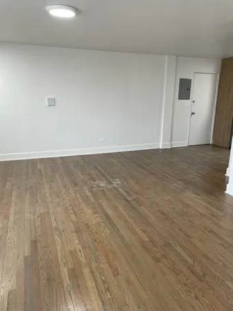 a view of an empty room and wooden floor