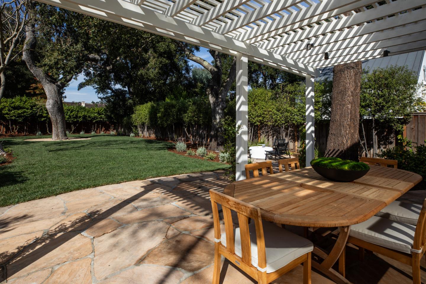 90 Macbain Avenue Atherton, CA 94027 - Photo 17 of 19 a view of a patio with table and chairs and potted plants