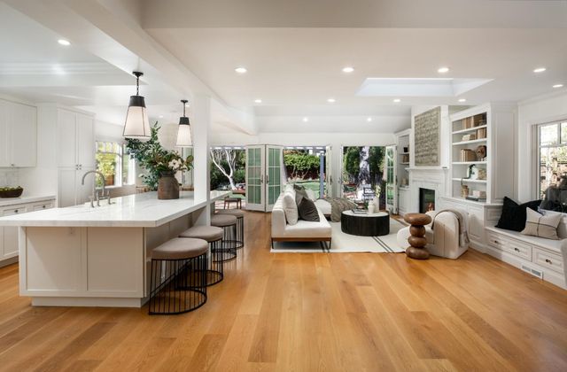 a living room with fireplace furniture and a large window