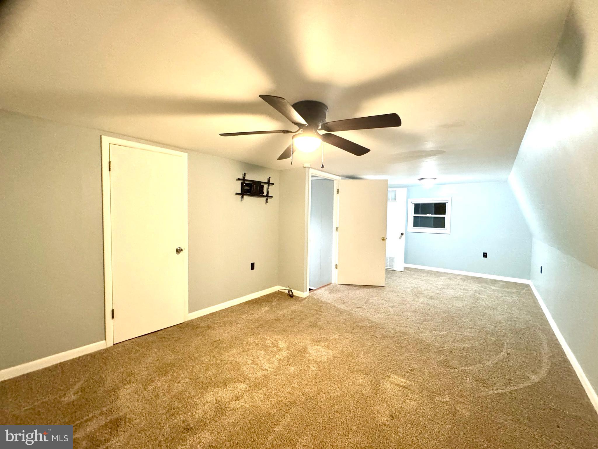 4695 Shelltown Road Marion Station, MD 21838 - Photo 22 of 31 a view of a big room with wooden floor and a ceiling fan