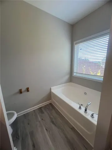 a bathroom with a tub and a window