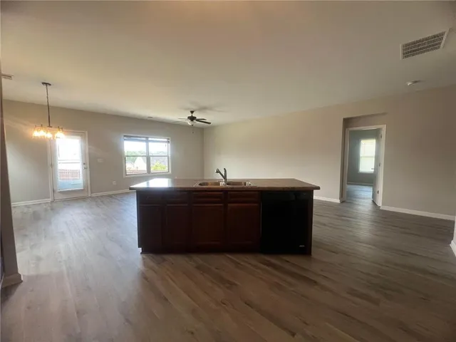 a living room with hard wood flooring and furniture