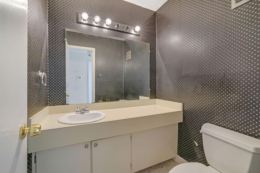 3312 Northcrest Road, Unit C Atlanta, GA 30340 - Photo 2 of 27 a bathroom with a sink a toilet and mirror