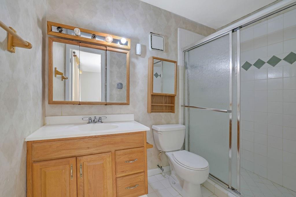 3312 Northcrest Road, Unit C Atlanta, GA 30340 - Photo 6 of 27 a bathroom with a granite countertop sink toilet and shower