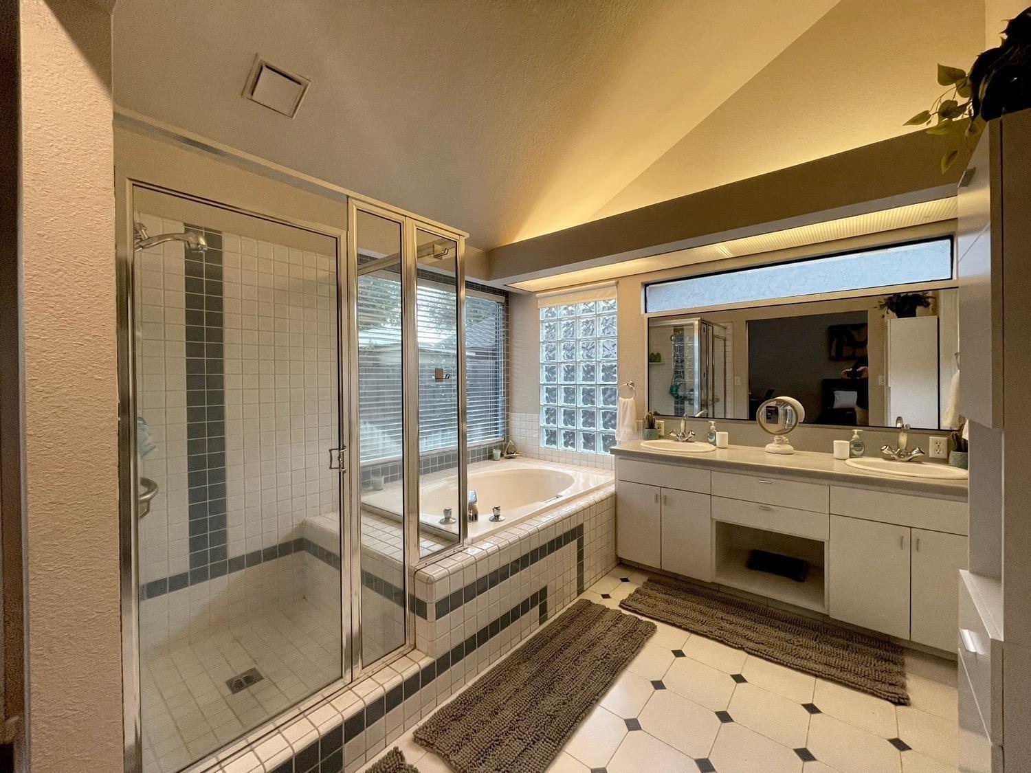 1956 Richert Avenue Clovis, CA 93611 - Photo 13 of 18 a bathroom with a tub sink shower and mirror