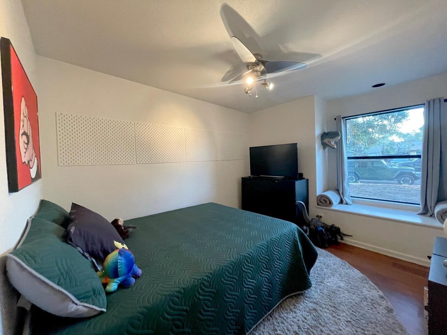1956 Richert Avenue Clovis, CA 93611 - Photo 10 of 18 a bedroom with a bed window and a television